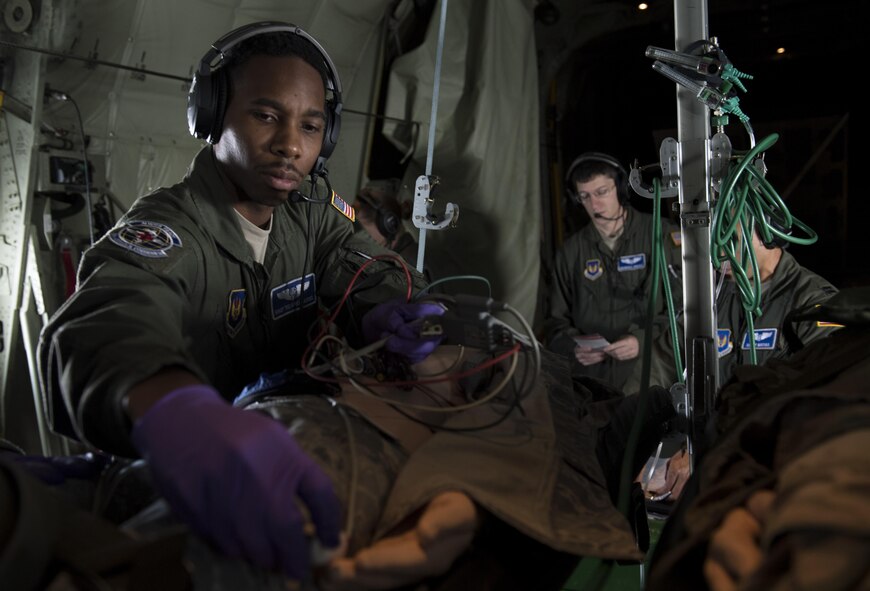 U.S. Air Force Staff Sgt. Tedario Cassel, 86th Aeromedical Evacuation Squadron aeromedical evacuation technician, places a monitor on the finger of a medical dummy during a training mission aboard a C-130J Super Hercules flying to Morón Air Base, Spain, Aug. 15, 2017. During the training mission, the 86th AES Airmen participated in scenarios including respiratory and cardiac emergencies and aircraft emergencies. (U.S. Air Force photo by Senior Airman Tryphena Mayhugh)