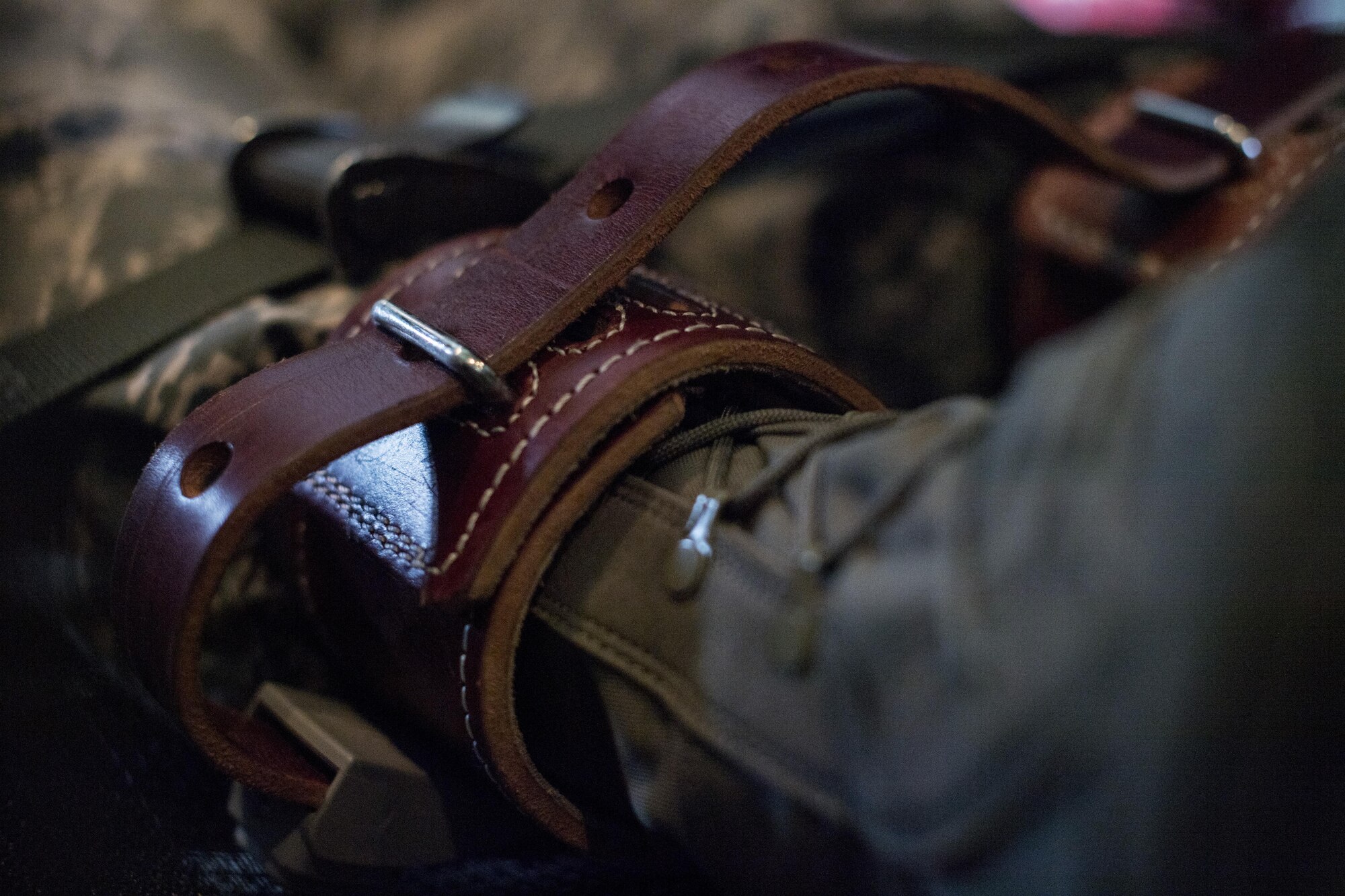 Safety straps restrain U.S. Air Force Chief Master Sgt. Eric Paddock, 86th Operations Group superintendent, as he simulates an irate patient during the 86th Aeromedical Evacuation Squadron’s training mission enroute to Ramstein Air Base, Germany, Aug. 17, 2017. The 86th AES conducted training for a variety of scenarios, including cardiac and respiratory emergencies, aircraft emergency protocols, and how to handle an irate patient. (U.S. Air Force photo by Senior Airman Tryphena Mayhugh)