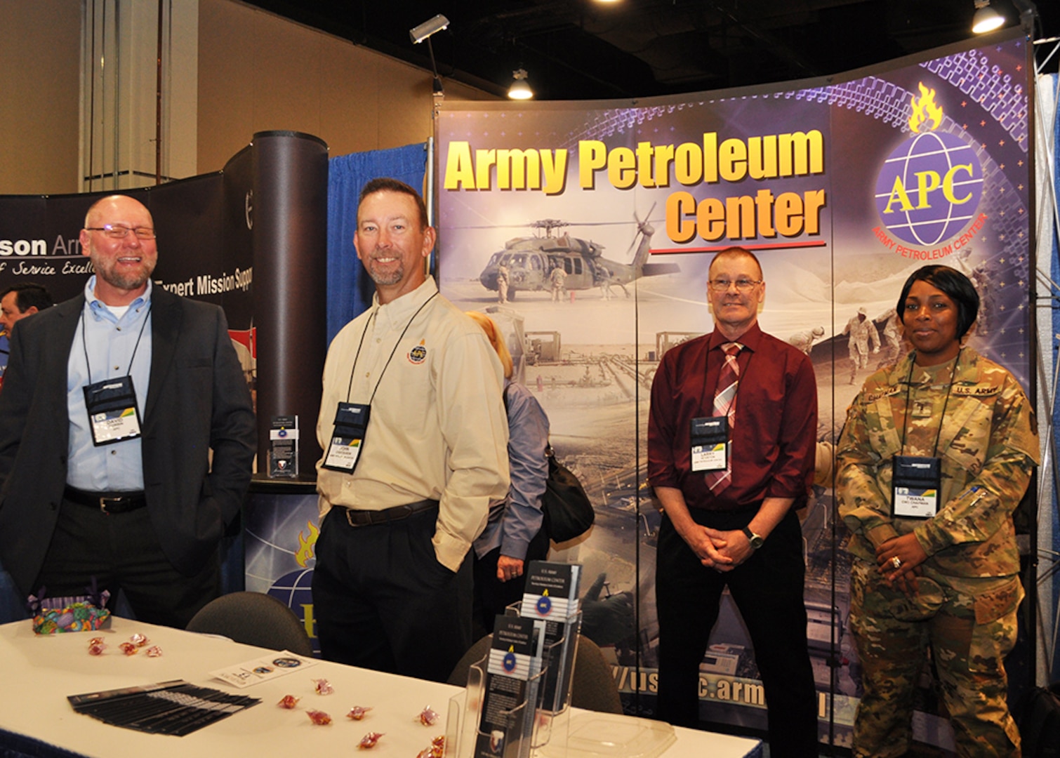 Army Petroleum Center employees stand in booth