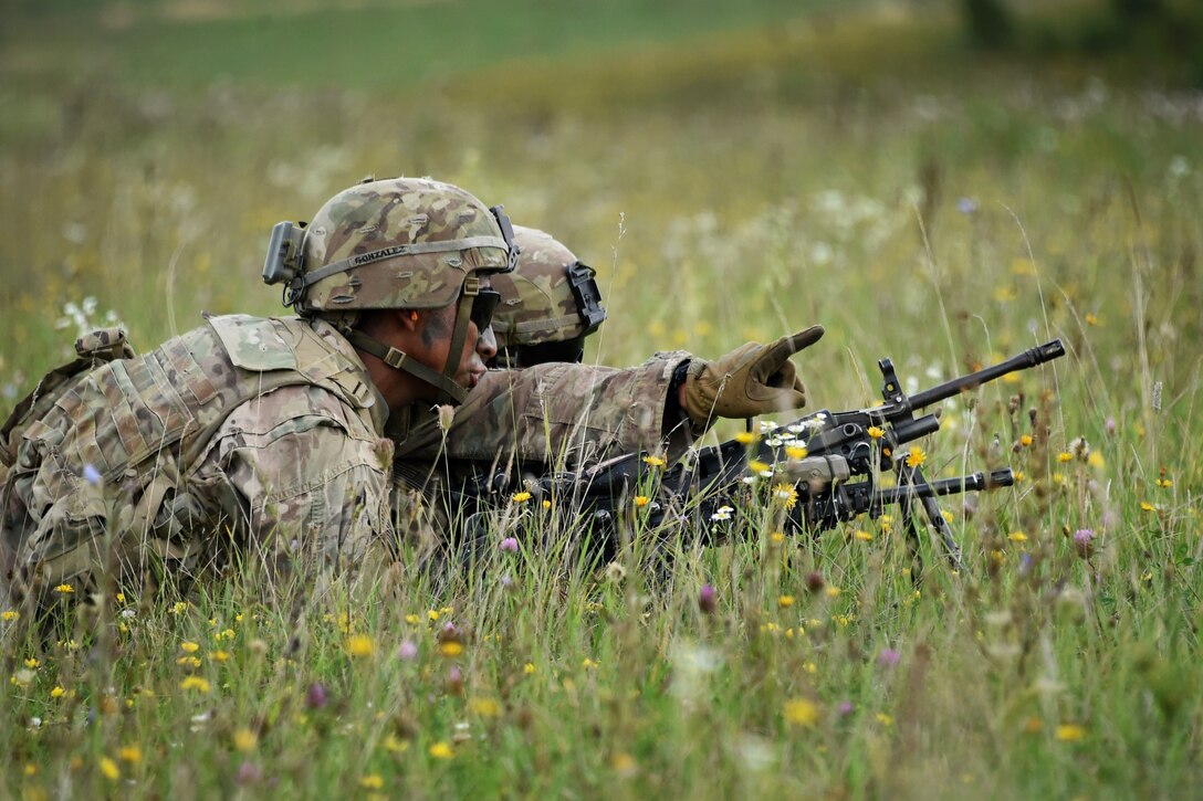 A soldier points toward their follow on objective.