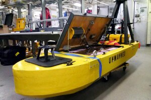 A yellow unmanned vehicle sits on display.