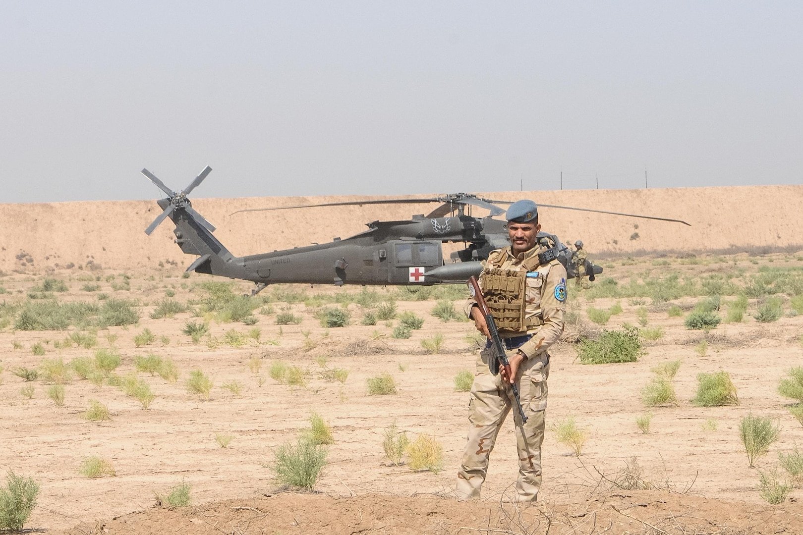 A member of the Iraqi Security Forces establishes a security perimeter around an HH-60M Black Hawk helicopter from the 2-149th General Support Aviation Battalion, Task Force Rough Riders, during the aerial response force exercise at Camp Taji Military Complex, Iraq, August 13,2017. The ISF provided security to an HH-60M Black Hawk helicopter that had been grounded due to simulated maintenance issues. This training is part of the overall Combined Joint Task Force – Operation Inherent Resolve building partner capacity mission which focuses on training and improving the capability of partnered forces fighting ISIS. CJTF-OIR is the global Coalition to defeat ISIS in Iraq and Syria. (US Army Photo by Capt. Stephen James)