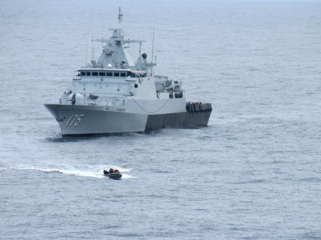 Sailors from the Royal Malaysian Navy corvette KD Kelantan approach the Military Sealift Command fleet replenishment oiler USNS Rappanhannock.