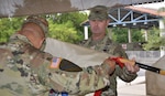 Col. Jeffrey Burris (right) and Command Sgt. Maj. Charles Williams (left) unfurl the colors during the 410th Contracting Support Brigade's uncasing ceremony Aug. 15 at the U.S. Army Medical Department Museum, Joint Base San Antonio-Fort Sam Houston, Texas. Burris is the 410th CSB commander, and Williams is the 410th CSB sergeant major.
