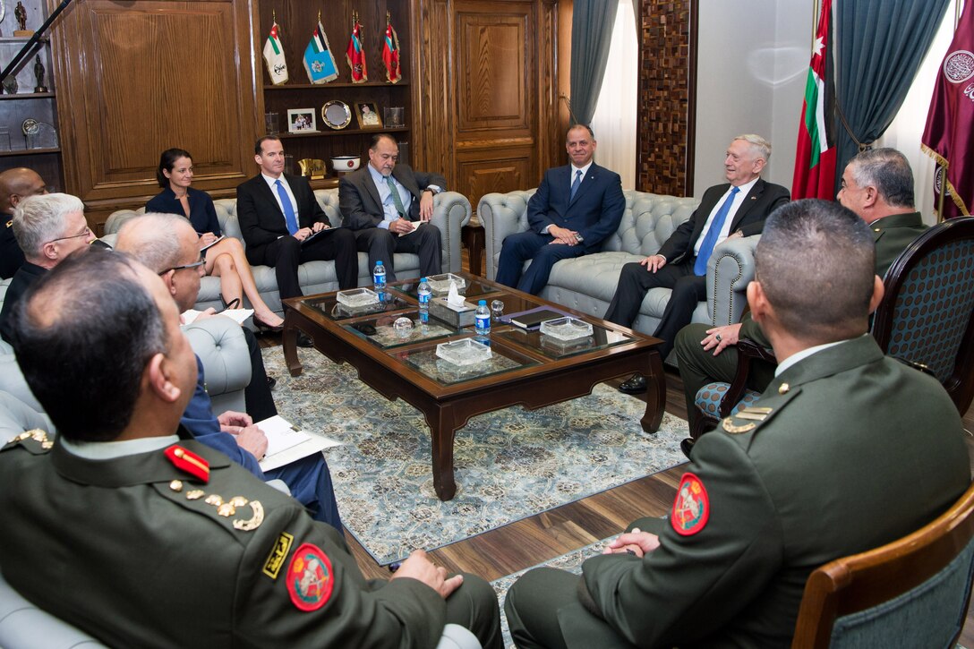 Defense Secretary Jim Mattis speaks to a prince of Jordan with a group of people present.