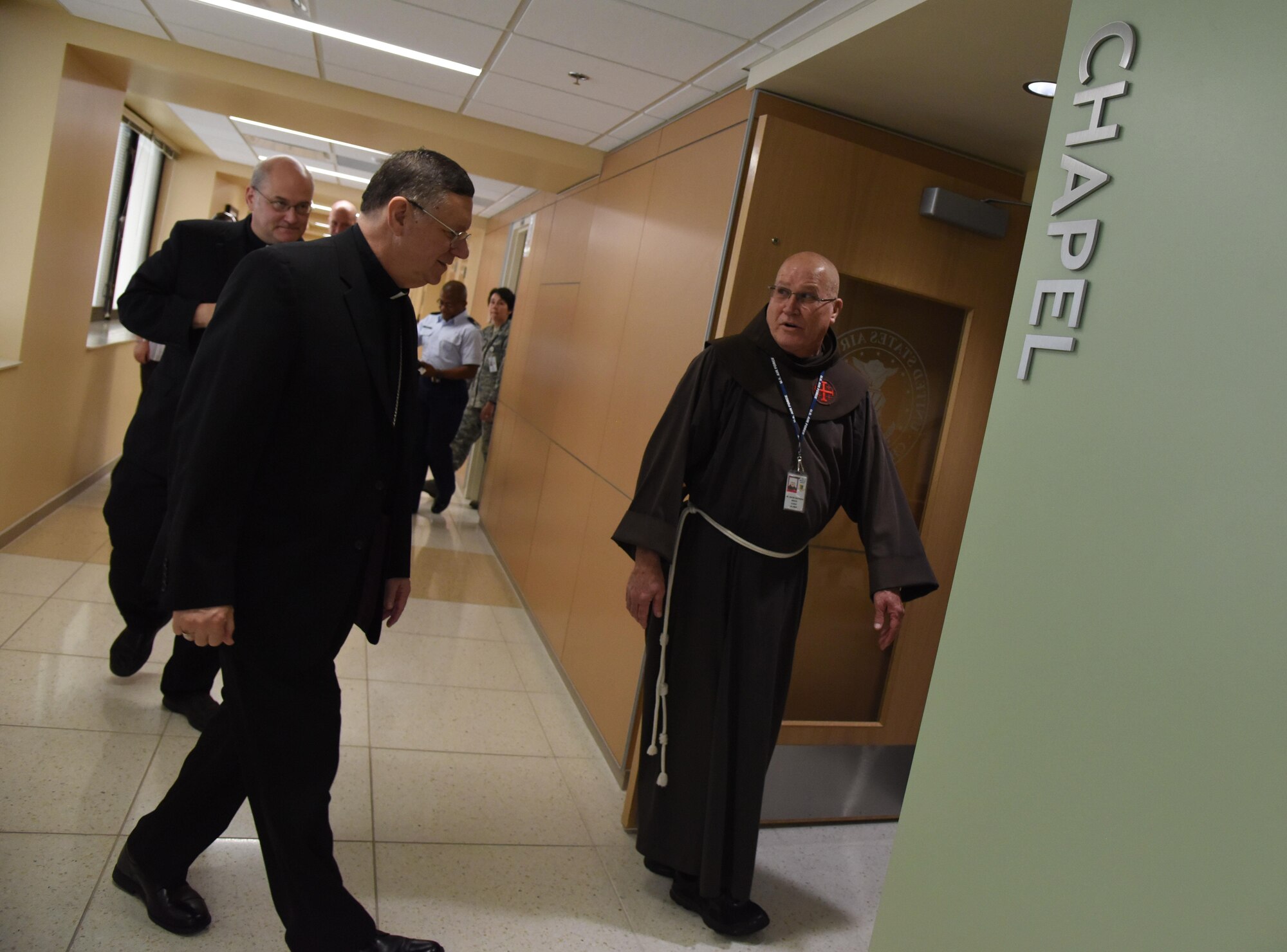 Father Jacob Matthew Smith, 81st Medical Group clergy, provides a tour of the Keesler Medical Center Chapel to The Most Reverend Louis Kihneman, III, Bishop of Biloxi Roman Catholic Diocese of Biloxi, and The Very Reverend Monsignor T. Dominick Fullam, J.C. L. Vicar General-Moderator of the Curia Roman Catholic Diocese of Biloxi, Aug. 17, 2017, on Keesler Air Force Base, Miss. The purpose of the visit was to familiarize Bishop Kihneman and Monsignor Fullam with the missio , facilities and faith programs of the 81st Training Wing and the 403rd Wing. (U.S. Air Force photo by Kemberly Groue)