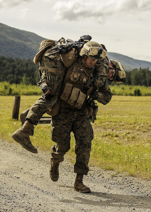 A U.S. Marine with Super Squad Competition 1st Squad, out of 1st Battalion, 25th Marine Regiment, 4th Marine Division, Marine Forces Reserve, fires at hostile target in a Shoot House during the Combat Marksmanship Endurance Test Phase III on Joint Base Elmendorf-Richardson, Alaska, Aug. 9, 2017.