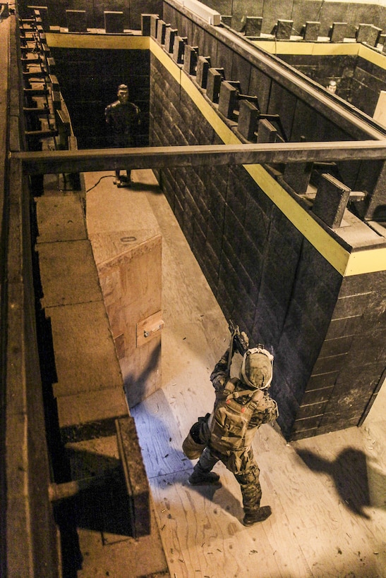 A U.S. Marine with Super Squad Competition 1st Squad, out of 1st Battalion, 25th Marine Regiment, 4th Marine Division, Marine Forces Reserve, fires at hostile target in a Shoot House during the Combat Marksmanship Endurance Test Phase III on Joint Base Elmendorf-Richardson, Alaska, Aug. 9, 2017.