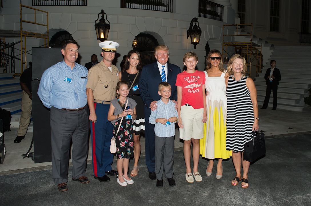 President Donald Trump, First Lady Melania and their son Barron participate in a group photo.