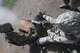 Gunner Staff Sgt. Joshua Hopkins fires the M2 .50 caliber machine gun while assistant gunner U.S. Petty Officer 3rd Class Derek Dick monitors ammunition during heavy weapons firing on Fort Bliss' Range 39. Heavy weapons firing is just one part of the Air Force Security Forces Center Desert Defender Ground Combat Readiness Training Center's basic security course. The course is typically taken just prior to a security forces member's deployment to a forward location. (U.S. Air Force photo by Debbie Aragon)