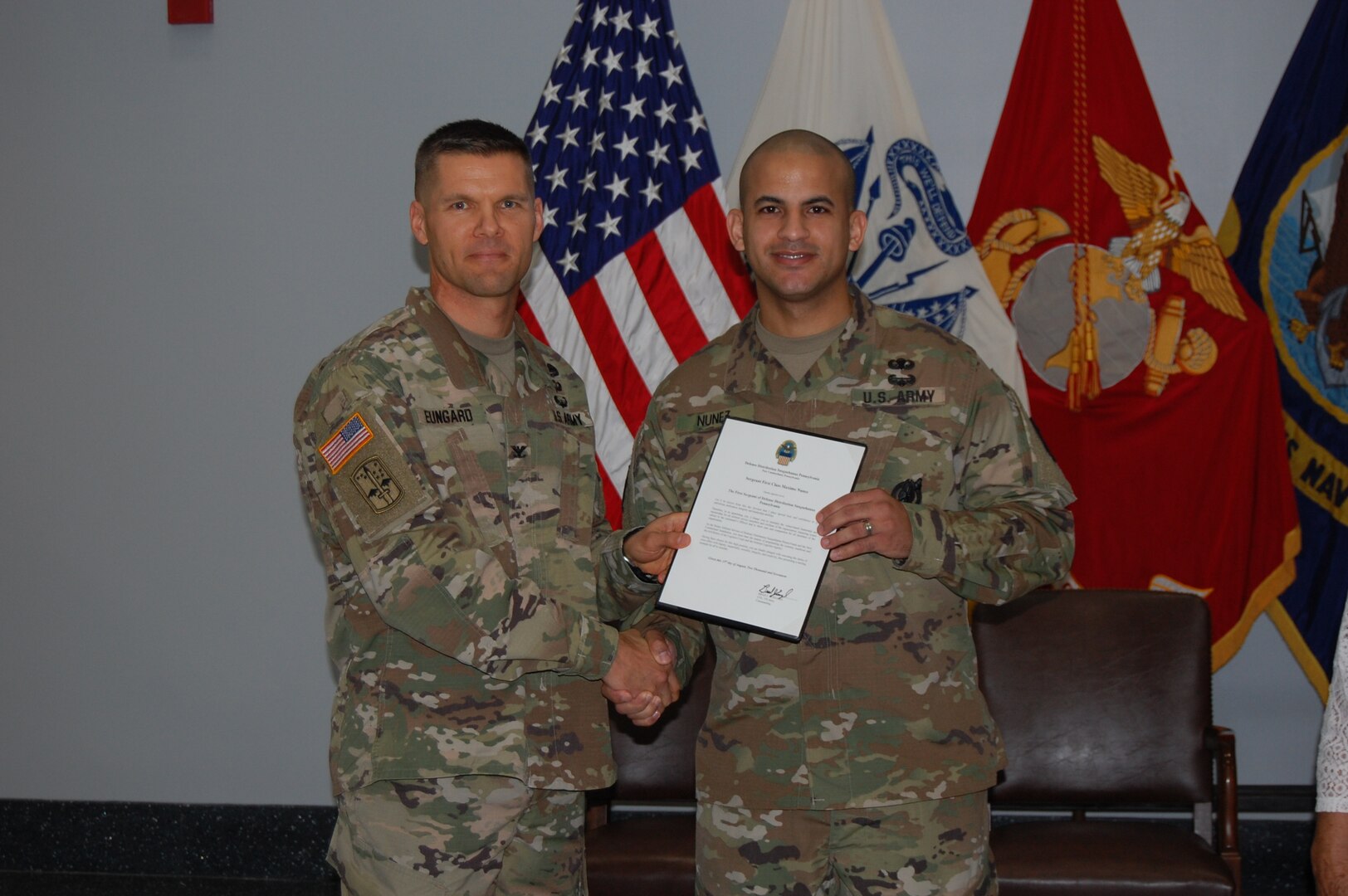 U.S. Army Col. Brad J. Eungard, commander of Defense Logistics Agency (DLA) Distribution Susquehanna, Pa., hands the formal certificate of promotion to U.S. Army 1st Sgt. Maximo Nunez after Nunez assumed responsibility as DLA Distribution, Susquehanna, Pa. Installation Senior Enlisted Advisor and 1st Sgt. during a ceremony held August 15, 2017 at the DLA Distribution Center, Susquehanna, Pa.
