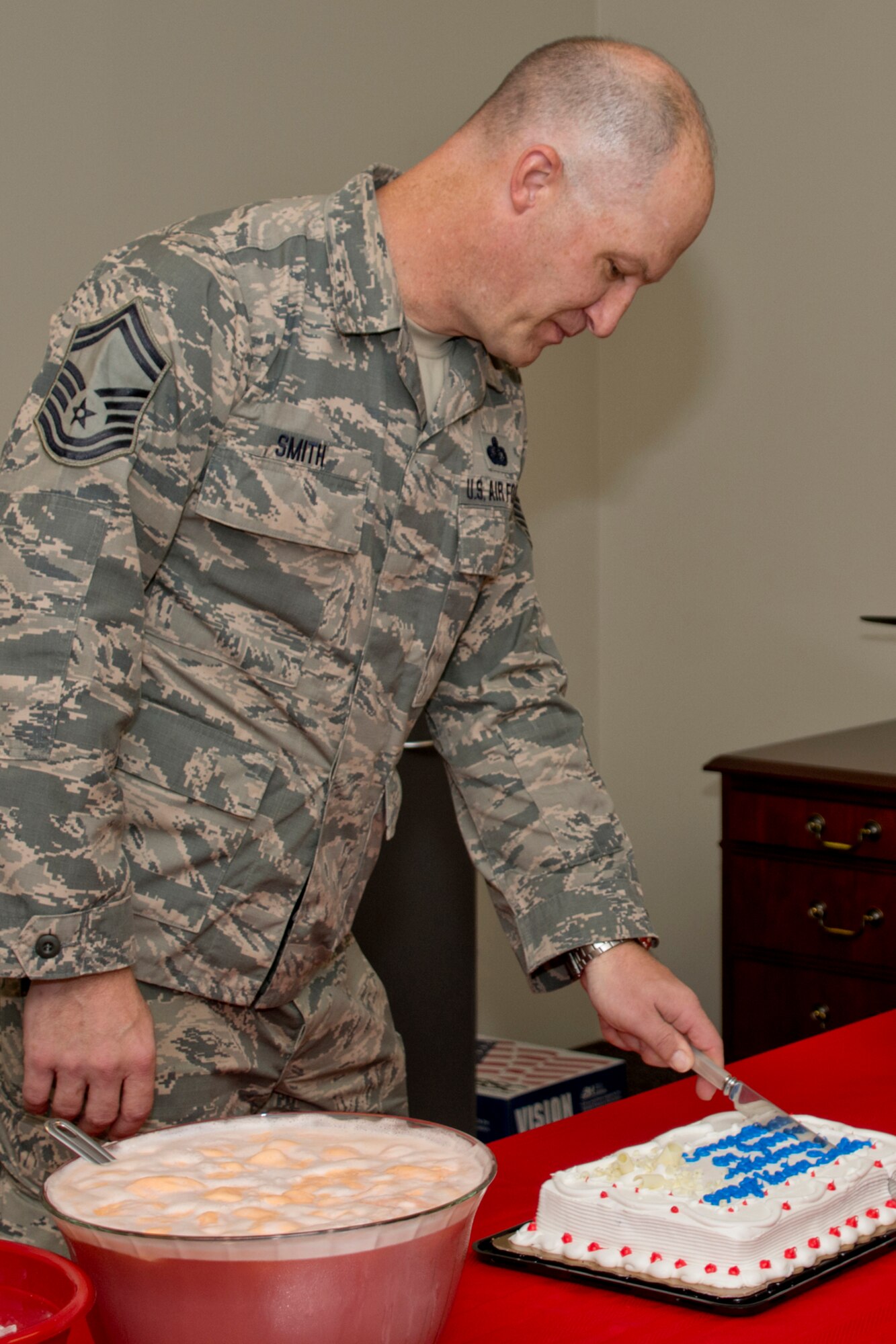 U.S. Air Force Reserve Senior Master Sgt. Kevin Smith, senior non-commissioned officer for sustainment services, 913th Force Support Squadron, cuts a cake at a retirement reception Aug. 21, 2017, at Little Rock Air Force Base, Ark. Smith retires today after 23 years of faithful service to his country. (U.S. Air Force photo by Master Sgt. Jeff Walston/Released)