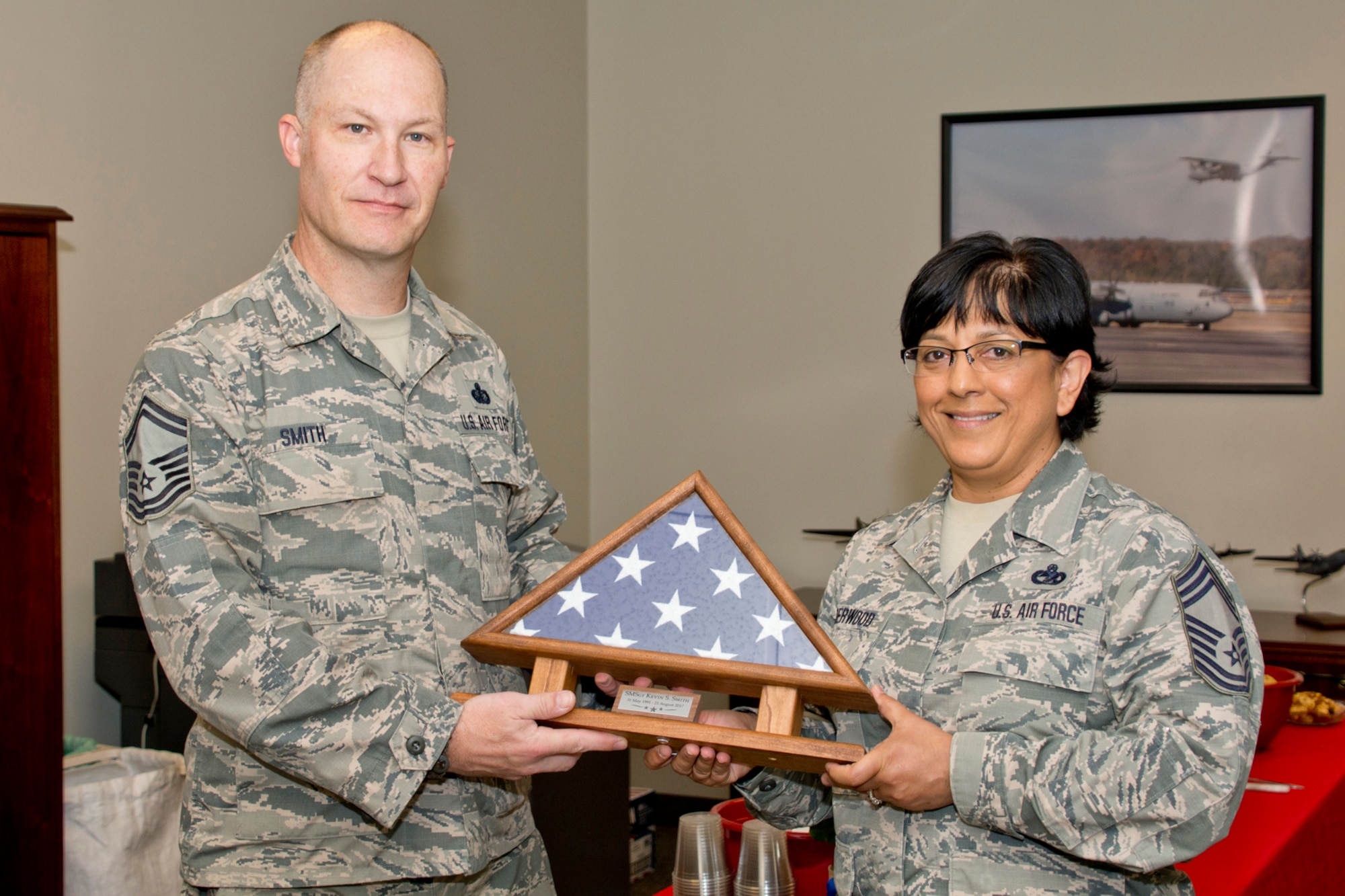 U.S. Air Force Reserve Chief Master Sgt. Cynthia Underwood, superintendent, 96th Aerial Port Squadron, poses for a photo with Senior Master Sgt. Kevin Smith, senior non-commissioned officer for sustainment services, 913th Force Support Squadron, Aug. 21, 2017, at Little Rock Air Force Base, Ark. Smith will retire after 23 years of faithful military service. (U.S. Air Force photo by Master Sgt. Jeff Walston/Released)