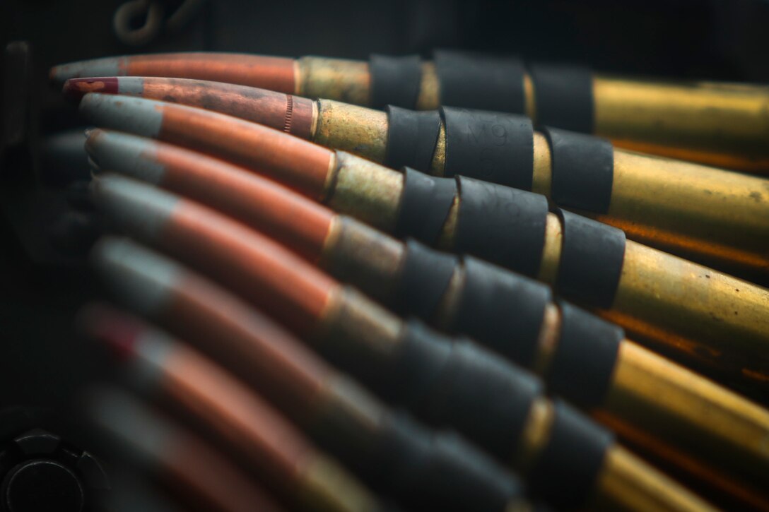 A belt of .50 caliber rounds are being fed into an M2 .50 caliber machine gun during Exercise Fuji Viper aboard Camp Fuji, Japan, August 1, 2017. Fuji Viper is a training exercise where Marines conduct live fire and non-live fire combined arms training in order to sustain combat proficiency and improve the lethality of the Marines in the U.S. Pacific Command area of operations. The Hawaii-based battalion is forward deployed to Japan as part of the Unit Deployment Program. (U.S. Marine Corps Photo by Cpl. Aaron S. Patterson)