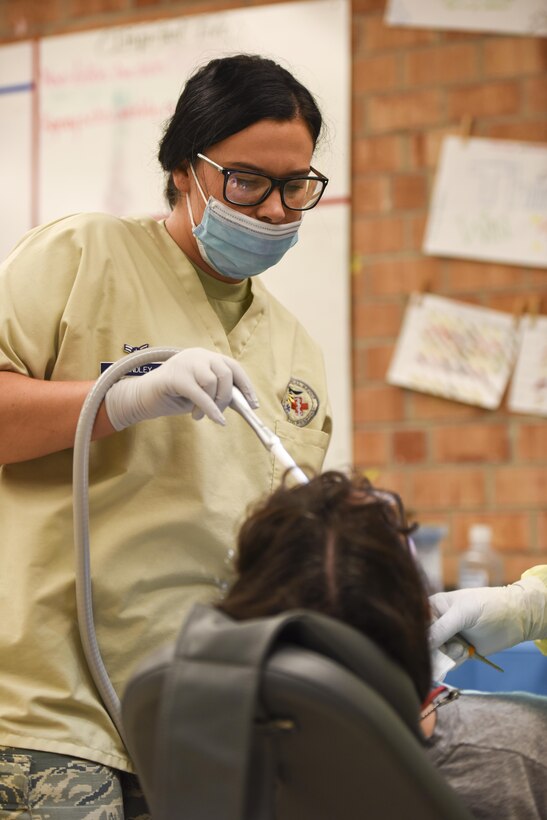 Air Force Airman 1st Class Carley Brindley, a dental assistant assigned to the 180th Fighter Wing, Ohio Air National Guard, provides suction during a dental procedure at Swain County High School during Smoky Mountain Medical Innovative Readiness Training in Bryson City, N.C., on Aug. 2, 2017. Smoky Mountain Medical IRT provides no cost medical, dental, vision and veterinary services to the residents of Swain County, Clay County and the surrounding areas while satisfying training requirements for active, reserve and National Guard service members and units.