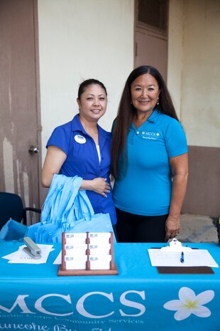 Marie Clavo and Kayla Marshall, Marine Corps Community Services employees, pose for a photo during an MCCS job fair aboard Marine Corps Base Hawaii, Aug. 17, 2017.The job fair provided personnel, on and off base, with possible work opportunities and on the spot interviews in the food, hospitality and retail departments. (U.S. Marine Corps photo by Lance Cpl. Autumn Rodenhizer)