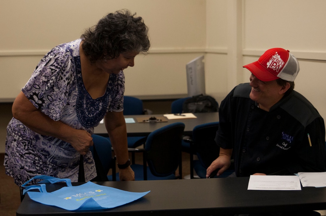 Darrell Kunisake, the manager of Samuel Adams Sports Grill, conducts an interview with a potential employee during an Marine Corps Community Services job fair aboard Marine Corps Base Hawaii, Aug. 17, 2017. The job fair provided personnel, on and off base, with possible work opportunities and on the spot interviews in the food, hospitality and retail departments. (U.S. Marine Corps photo by Lance Cpl. Autumn Rodenhizer)