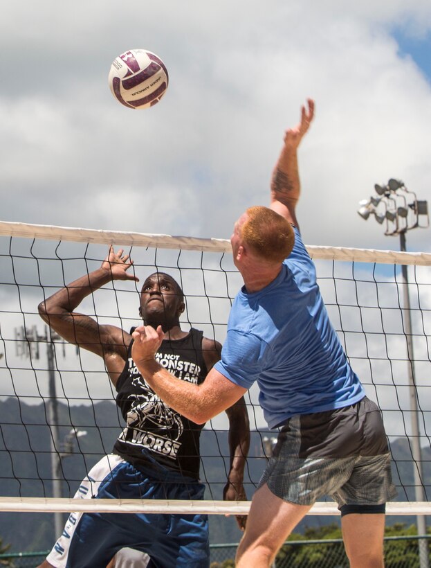 Staff Sgt. Jonathan Turner, a data network staff noncommissioned officer with Headquarters Battalion, Marine Corps Base Hawaii, jumps up to block a volleyball spike from Sgt. Christopher Shank, a Marine Air-Ground Task Force planner with Marine Aircraft Group 24, during the semi-finals of the “101 Days of Summer” volleyball tournament at Riseley Field aboard Marine Corps Base Hawaii (MCBH), August 17, 2017. The tournament was part of Semper Fit’s “101 Days of Summer,” where MCBH units would compete against one another to win funding for their Marine Corps Ball, with MAG-24 taking home the title of champions. (U.S. Marine Corps photo by Lance Cpl. Isabelo Tabanguil)