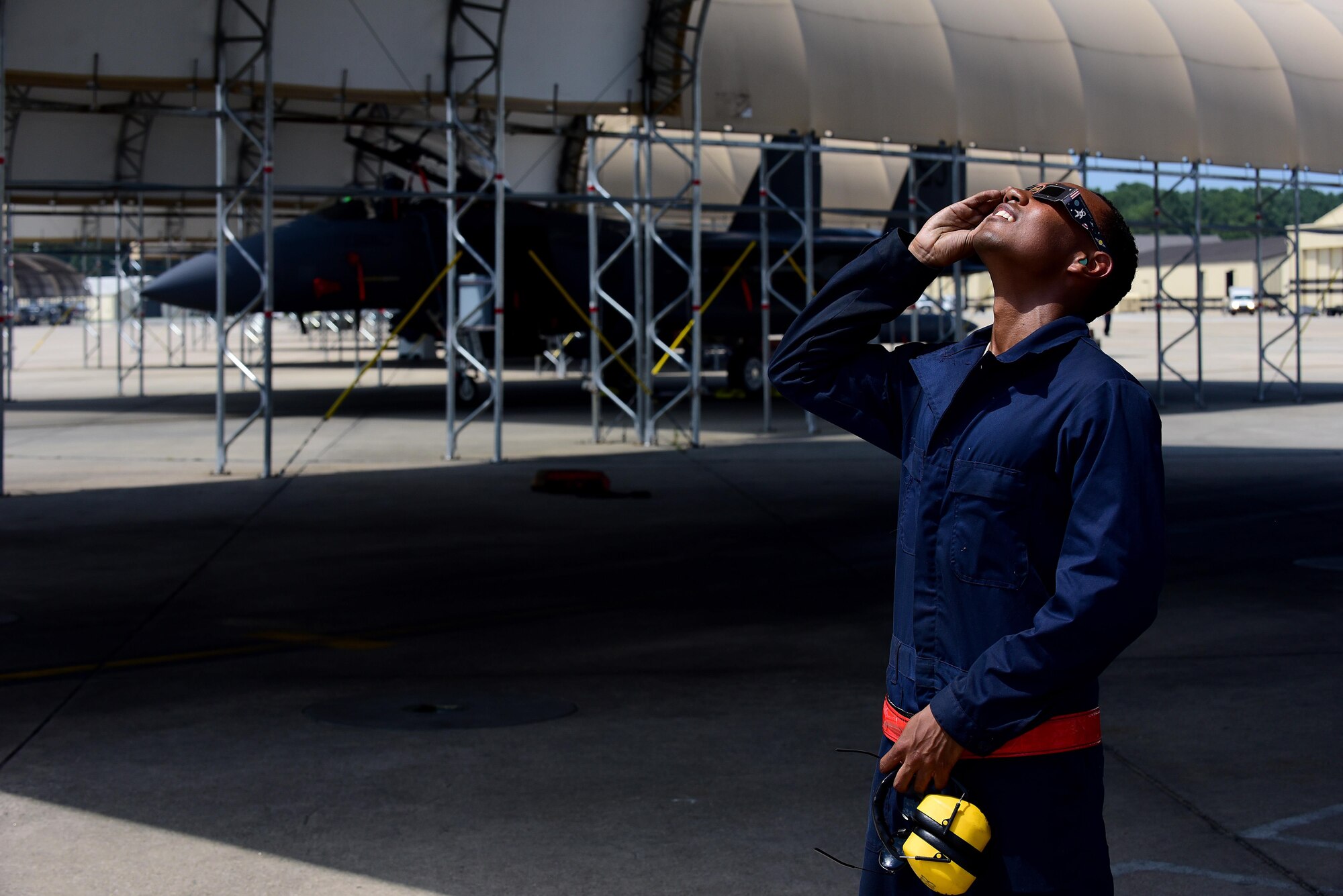 Airman 1st Class Tariq Baker, 4th Operations Support Squadron crew chief, views a solar eclipse, Aug. 21, 2017, at Seymour Johnson Air Force Base, North Carolina. Only six percent of the sun was visible over base during the peak of the eclipse. (U.S. Air Force photo by Airman 1st Class Kenneth Boyton)