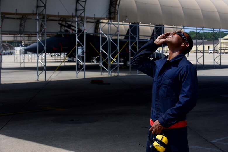 Airman 1st Class Tariq Baker, 4th Operations Support Squadron crew chief, views a solar eclipse, Aug. 21, 2017, at Seymour Johnson Air Force Base, North Carolina. Only six percent of the sun was visible over base during the peak of the eclipse. (U.S. Air Force photo by Airman 1st Class Kenneth Boyton)