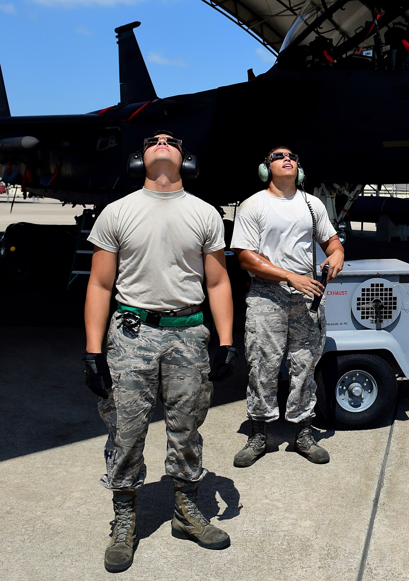 Members of Team Seymour use special eclipse glasses to view a solar eclipse, Aug. 21, 2017, at Seymour Johnson Air Force Base, North Carolina. During the short time when the moon completely obscures the sun, is it safe to look directly at the event. (U.S. Air Force photo by Airman 1st Class Kenneth Boyton)