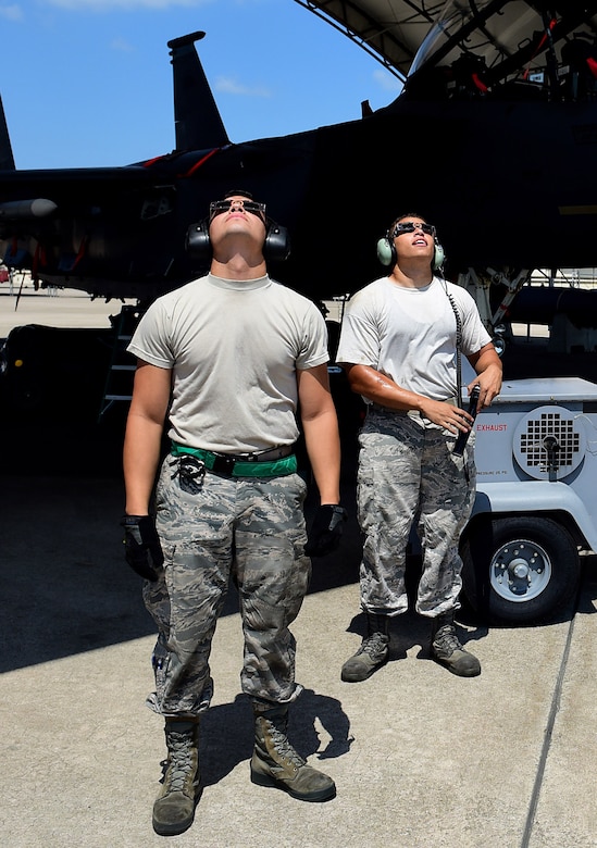 Members of Team Seymour use special eclipse glasses to view a solar eclipse, Aug. 21, 2017, at Seymour Johnson Air Force Base, North Carolina. During the short time when the moon completely obscures the sun, is it safe to look directly at the event. (U.S. Air Force photo by Airman 1st Class Kenneth Boyton)