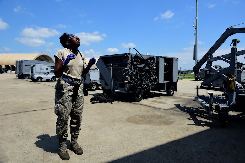 Airman 1st Class Janay Mack, 4th Equipment Maintenance Squadron aerospace ground equipment mechanic, looks at a solar eclipse, Aug. 21, 2017, at Seymour Johnson Air Force Base, North Carolina. Over the course of 100 minutes, 14 states across the United States experienced more than two minutes of darkness throughout the day. (U.S. Air Force photo by Airman 1st Class Kenneth Boyton)