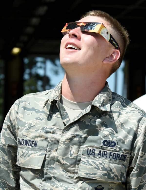 Senior Airman Austin Snowden, 4th Security Forces Squadron patrolman, observes the “Great American Solar Eclipse” using eclipse glasses, Aug. 21, 2017, at Seymour Johnson Air Force Base, North Carolina. Looking directly at a solar eclipse without proper eye protection is unsafe and can cause serious, permanent eye damage. (U.S. Air Force photo by Airman 1st Class Victoria Boyton)