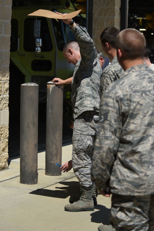 Members of team Seymour observe the “Great American Solar Eclipse” through a reflection on the ground, Aug. 21, 2017, at Seymour Johnson Air Force Base, North Carolina. Eclipse viewers on base observed 94% eclipse totality at 2:46 p.m. (U.S. Air Force photo by Airman 1st Class Victoria Boyton)