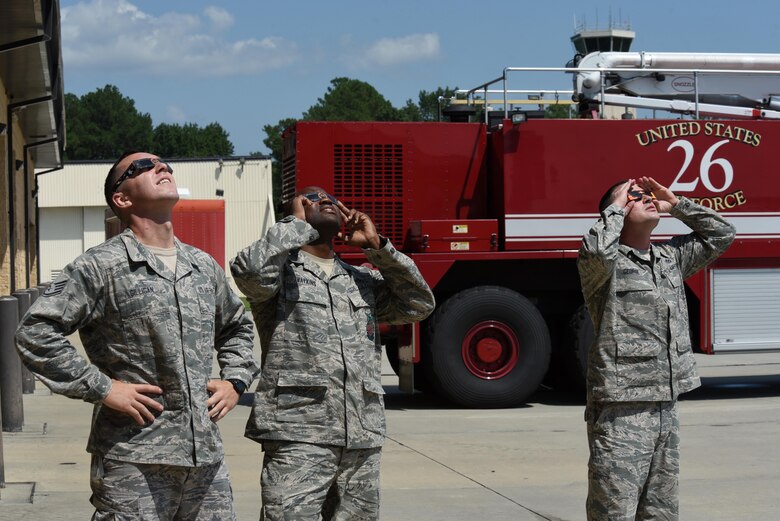 Members of team Seymour observe the “Great American Solar Eclipse” using eclipse glasses, Aug. 21, 2017, at Seymour Johnson Air Force Base, North Carolina. Eclipse viewers on base observed 94% maximum obstruction. (U.S. Air Force photo by Airman 1st Class Victoria Boyton)