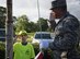 Staff Sgt. Michael Stanolevich, 96th Medical Group Honor Guardsman, teaches Michael King, Eglin Elementary School safety patrol member how to salute during Honor Guard flag detail training before class at Eglin Air Force Base, Fla. Aug. 15.  The HG made a visit to the school to train the safety patrol how to properly handle the flag during their daily flag detail. (U.S. Air Force photo/Ilka Cole)