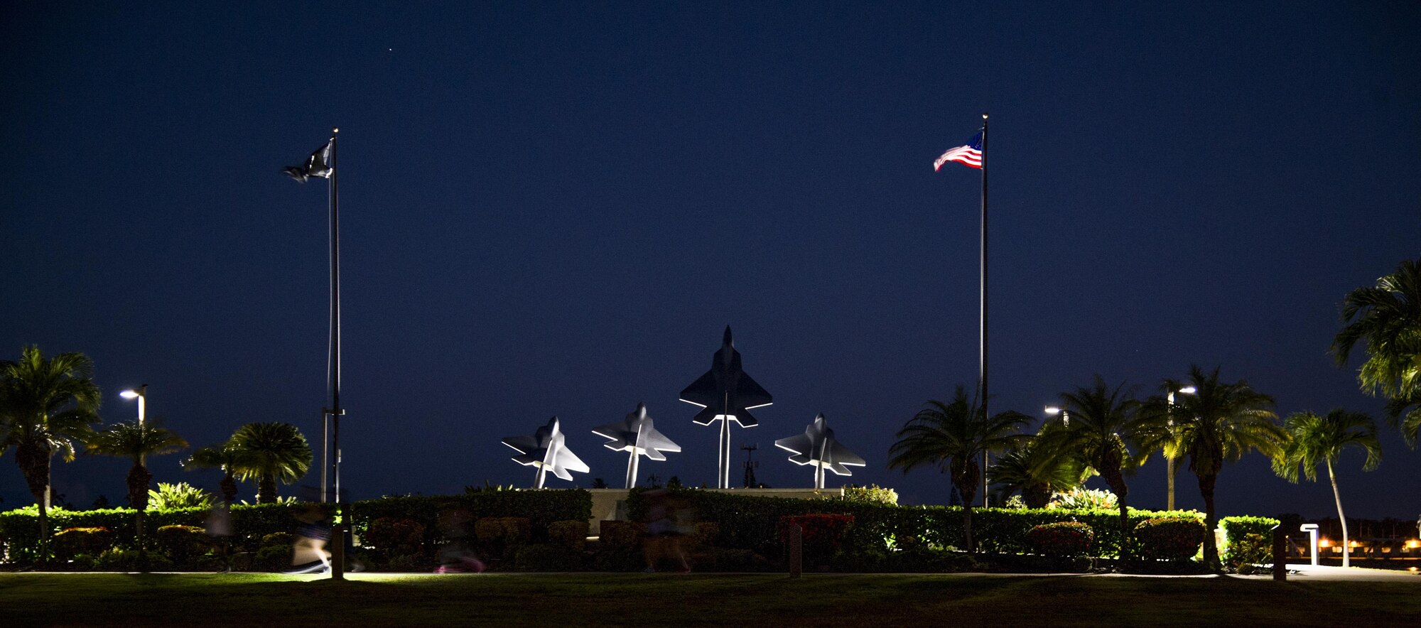 Participants run past the Missing Man Memorial during the 11th Annual Hickam Half Marathon, Joint Base Pearl Harbor-Hickam, Hawaii, Aug. 19, 2017.