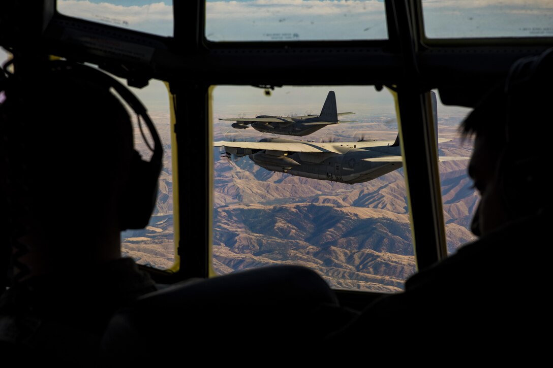 This image shows two pilots as they conduct navigational training.