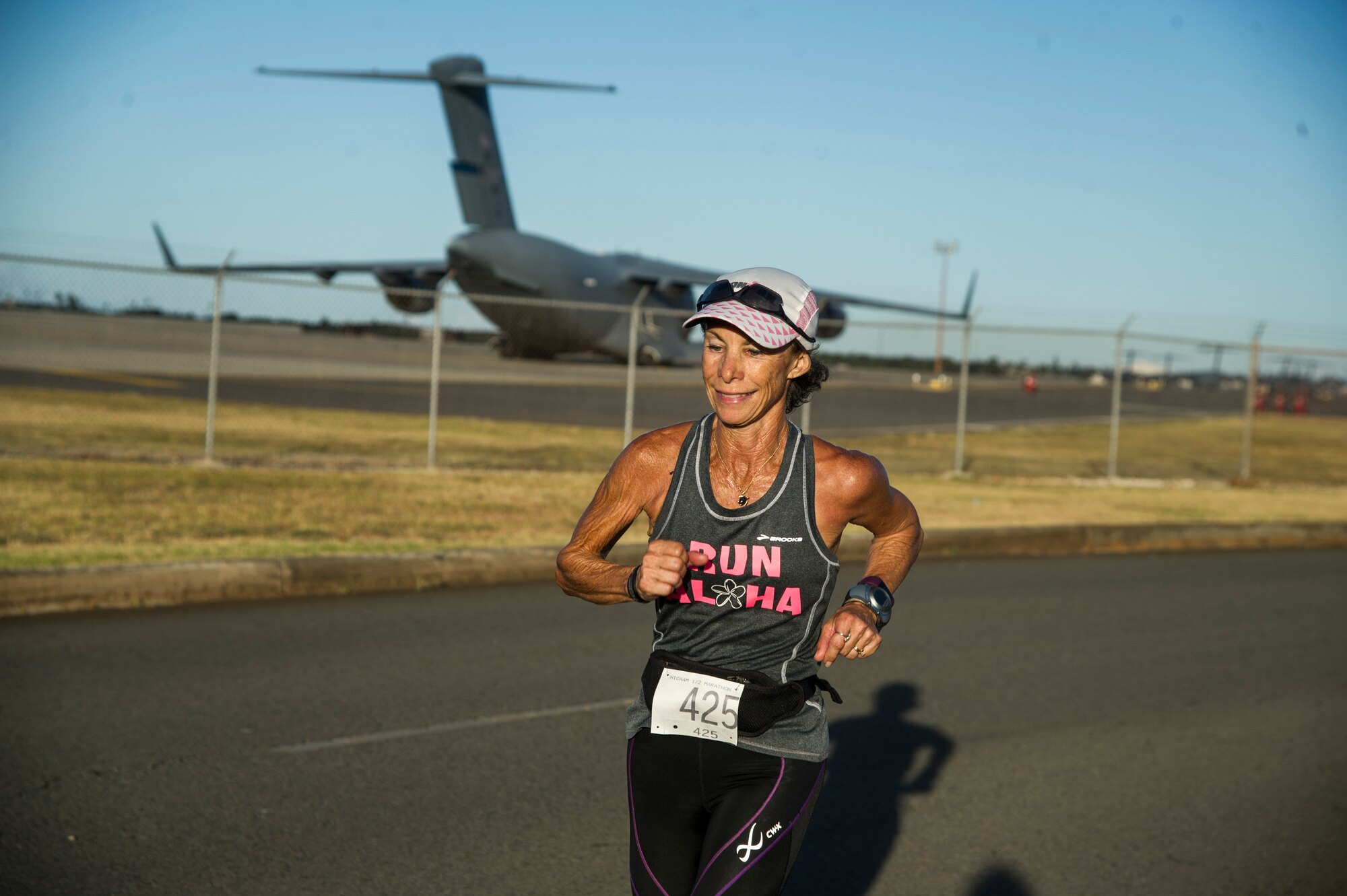 Yvette Flynn runs past the flight line during the 11th Annual Hickam Half Marathon, Joint Base Pearl Harbor-Hickam, Hawaii, Aug. 19, 2017.