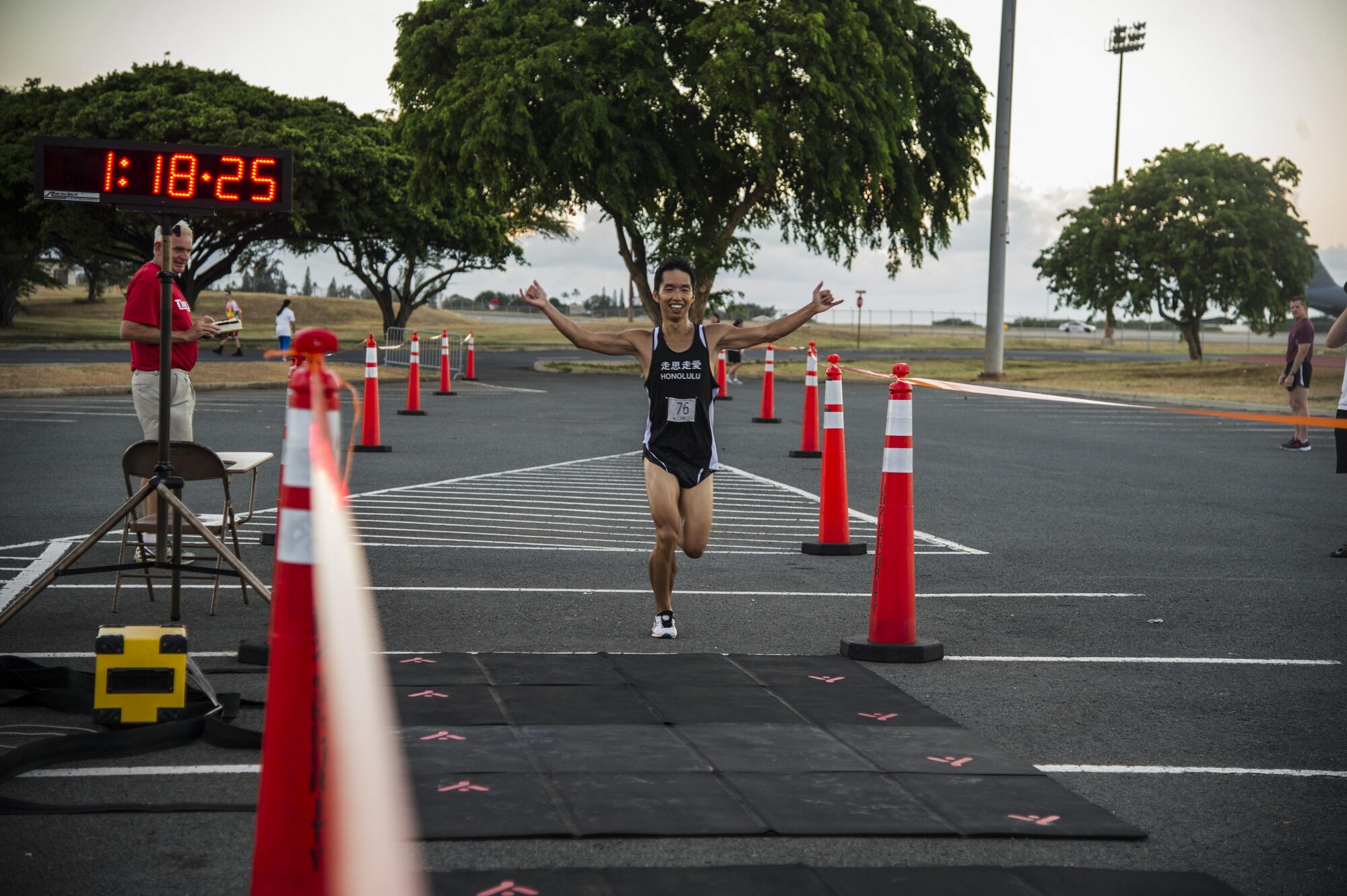 Kazuki Ishii crosses the finish line, taking first place in the male open category during the 11th Annual Hickam Half Marathon, Joint Base Pearl Harbor-Hickam, Hawaii, Aug. 19, 2017.