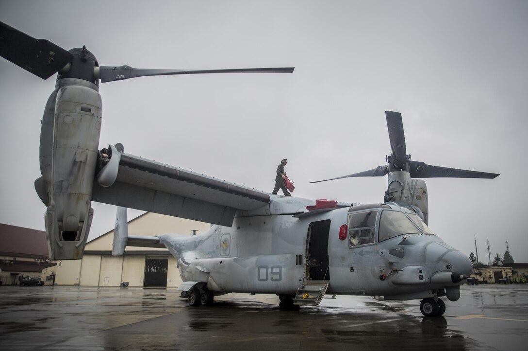 A U.S. Marine maintains a MV-22 Osprey at Misawa Air Base, Japan, August 9, 2017, signifying the start of exercise Northern Viper 2017.