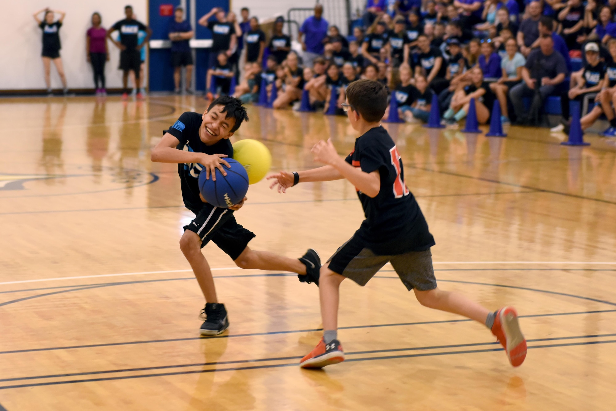 A red team student tags out a blue team student in a game of basket-dodgeball during ‘The RACE’ at Royal Air Force Lakenheath, England, Aug. 14, 2017. Students participating in ‘The RACE’ are encouraged to bring friends and classmates to join. (U.S. Air Force photo by Airman 1st Class John A. Crawford)
