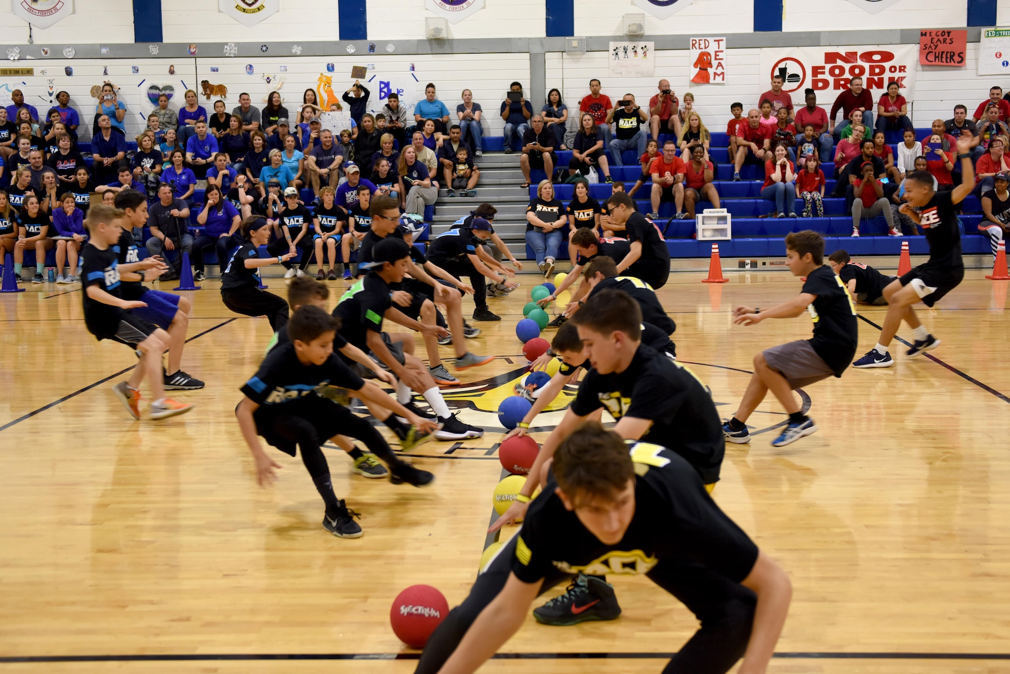 Students speed to the starting line in a game of dodgeball during ‘The RACE’ at Royal Air Force Lakenheath, England, Aug. 14, 2017. Students and their families participated in various events from dodgeball to dance-offs. (U.S. Air Force photo by Airman 1st Class John A. Crawford)