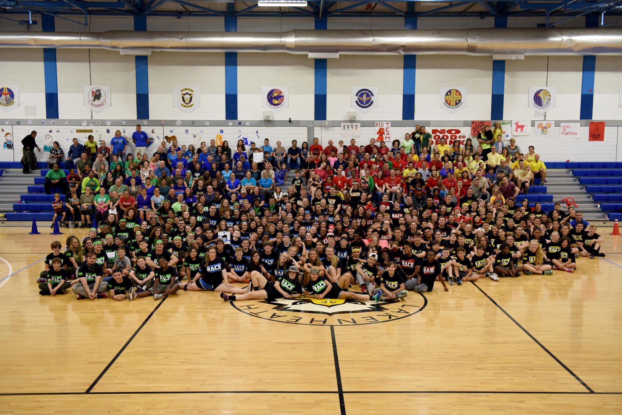 All students, their families and event coordinators pose for a photo during ‘The RACE’ at Royal Air Force Lakenheath, England, Aug. 14, 2017. ‘The RACE’ was created to help newly arrived dependents integrate into their elementary and high school. (U.S. Air Force photo by Airman 1st Class John A. Crawford)