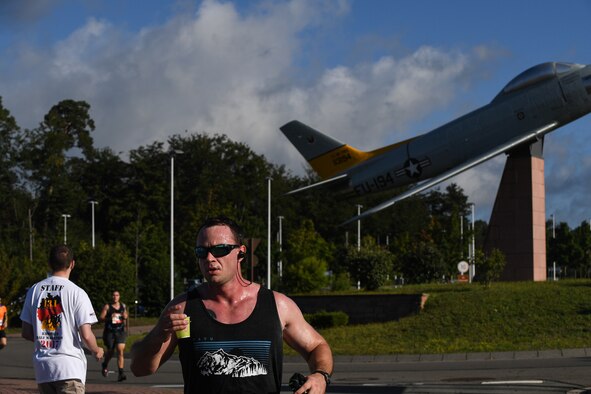 A Kaiserslautern Military Community member drinks water while completing the 7th annual Ramstein Half Marathon at Ramstein Air Base, Germany, Aug. 19, 2017