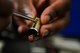 U.S. Air Force Senior Airman Andre Crawford, 786th Civil Engineer Squadron locksmith, puts pins into a lock on Ramstein Air Base, Germany, Aug. 14, 2017. The pins correspond with the height of cuts on a key, thereby enabling the key to open the lock. (U.S. Air Force photo by Airman 1st Class Joshua Magbanua)