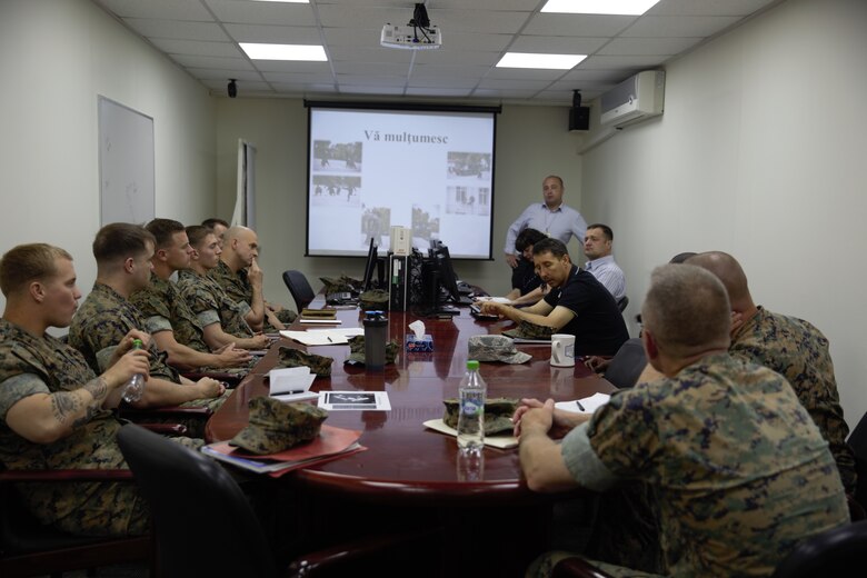 U.S. Marines and sailor with Black Sea Rotational Force 17.1 and Marine Rotational Force Europe 17.1 discuss with local Moldovan police capabilities during an embassy reinforcement exercise in Chisinau, Moldova, July 15, 2017. Embassy reinforcement exercises improve emergency preparedness.  (U.S. Marine Corps photo by Sgt. Patricia A. Morris)