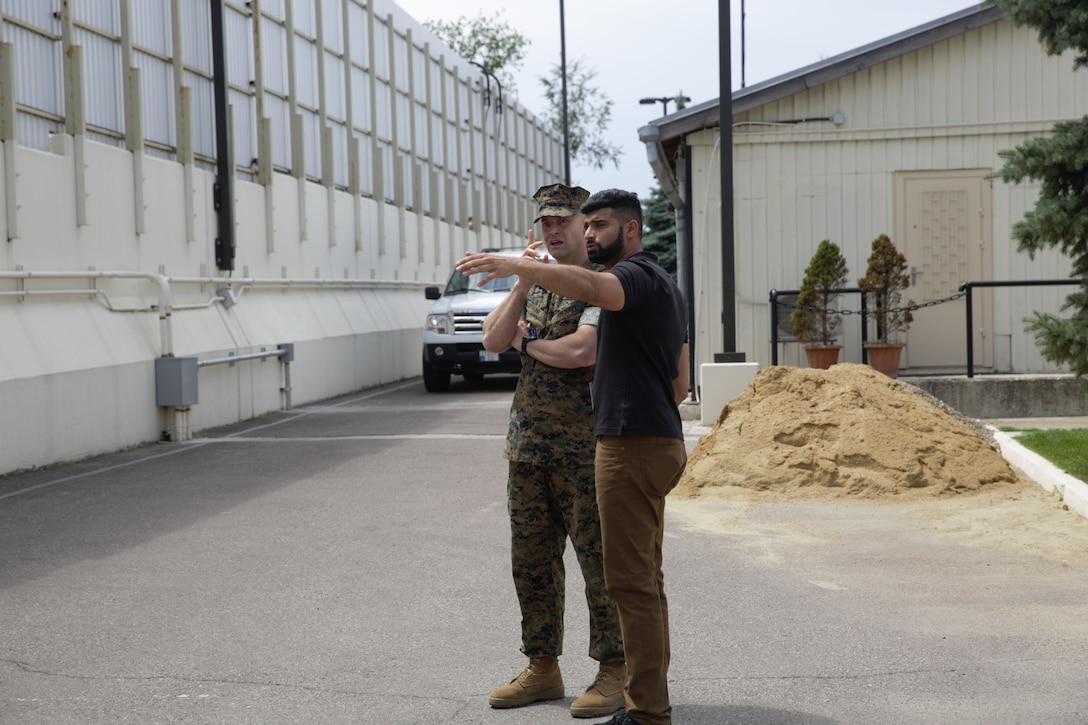 U.S. sailor with Marine Rotational Force Europe 17.1 discuss potential casualty collection points with an assistant regional security officer during an embassy reinforcement exercise in Chisinau, Moldova, July 15, 2017. Embassy reinforcement exercises improve emergency preparedness.  (U.S. Marine Corps photo by Sgt. Patricia A. Morris)