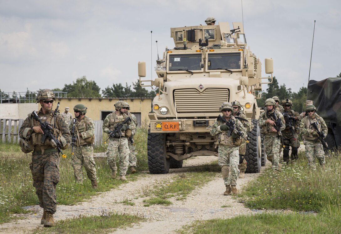 HOHENFELS, Germany – U.S. Marine 1st Lt. Matt Miller (left), a Charlie Company infantry advisor with the Georgia Deployment Program-Resolute Support Mission Georgia Liaison Team, and soldiers with the 31st Georgian Light Infantry Battalion, conduct a patrol while in route to a key leader engagement during the Georgia Deployment Program Mission Rehearsal Exercise aboard the Joint Multinational Readiness Center, Hohenfels, Germany, Aug. 17, 2017. The MRE is the culminating event of the GDP-RSM where GLT and Marines from 6th Air Naval Gunfire Liaison Company, Force Headquarters Group, Marine Forces Reserve, work alongside the 31st Georgian Light Infantry Battalion to prepare and demonstrate that they are ready to deploy to Afghanistan in support of Operation Freedom’s Sentinel.  (U.S. Marine Corps photo by Cpl. Kimberly Aguirre/Released)