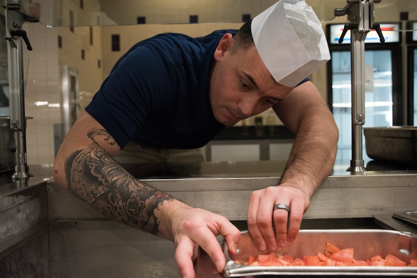 Soldier prepares salad toppings.