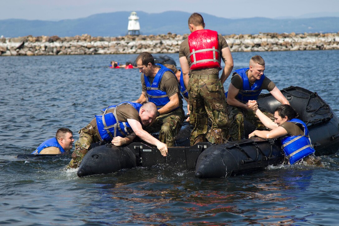 National Guardsmen load onto a zodiac boat.