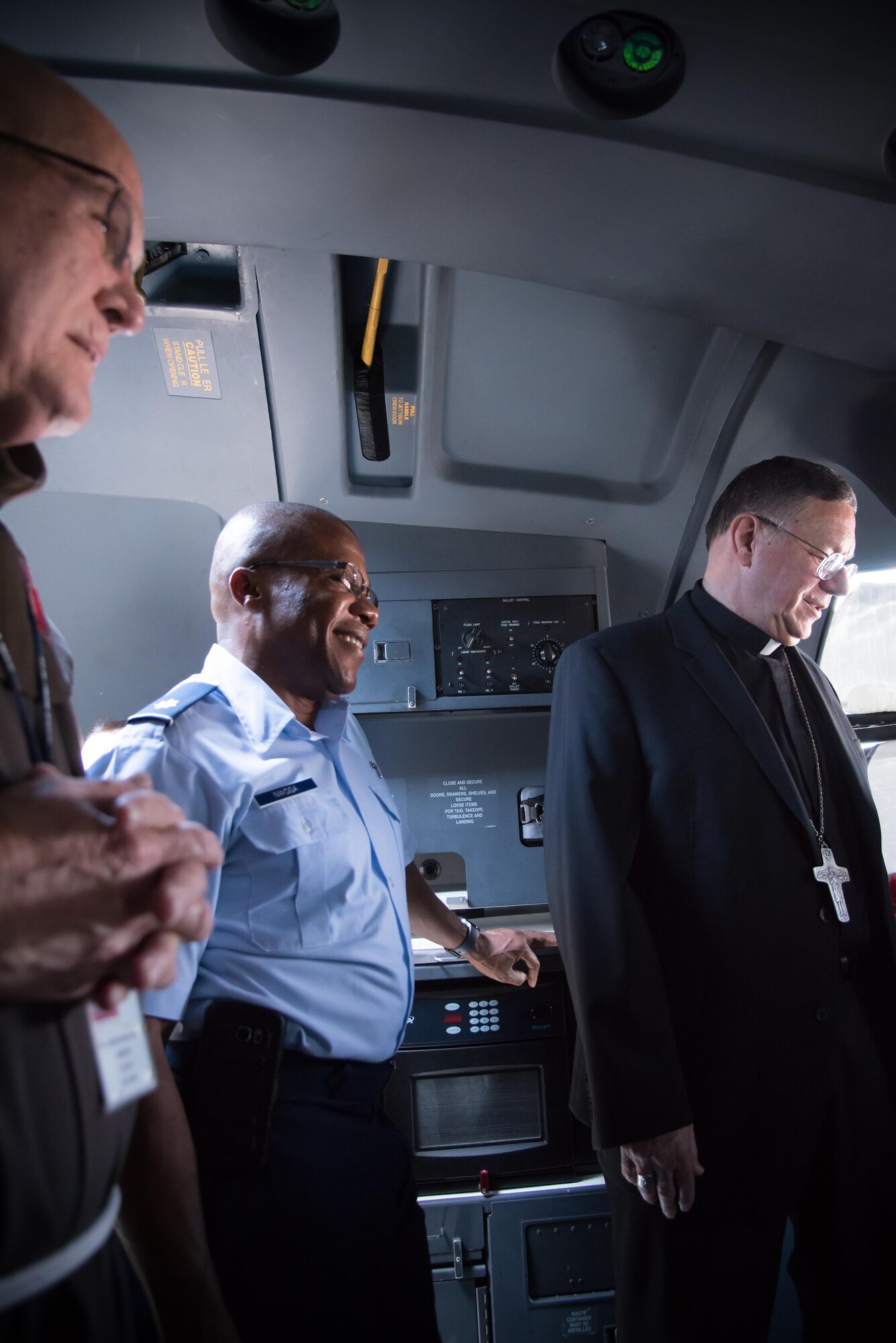 Chaplain (Maj.) Laserian Nwoga, 81st Training Wing, and the Bishop of Biloxi, Bishop Louis Kihneman, look inside the flight deck of a WC-130J Super Hercules aircraft Aug. 17, 2017 at Keesler Air Force Base, Miss. Kihneman visited the 403rd Wing to learn more about its mission and during his visit took a moment to bless the wing's fleet of aircraft.  (U.S. Air Force photo/Staff Sgt. Heather Heiney)