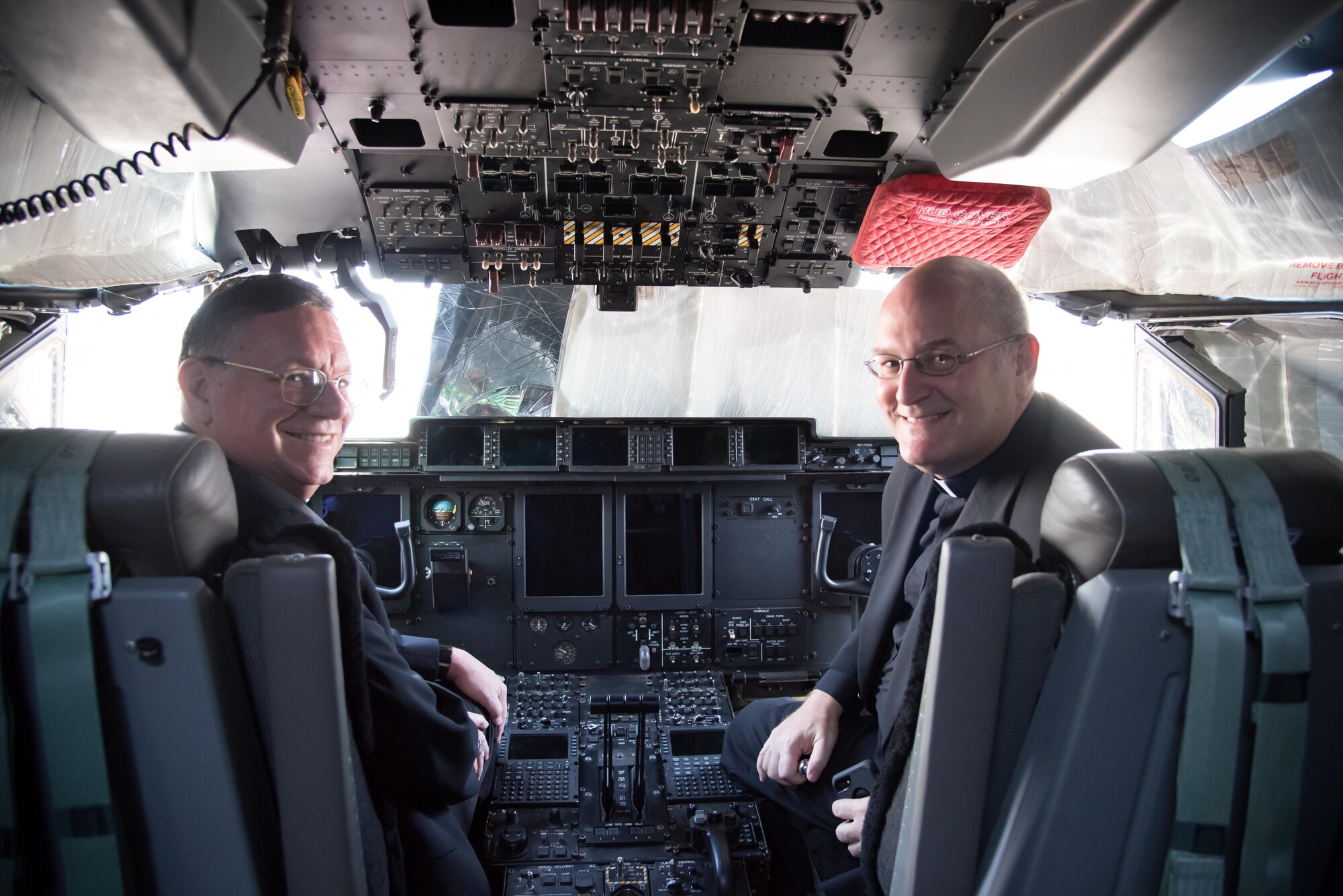 The Bishop of Biloxi, Bishop Louis Kihneman, and Monsignor Dominick Fullam pose for a photo in the flight deck of a WC-130J Super Hercules aircraft Aug. 17, 2017 at Keesler Air Force Base, Mississippi. Kihneman visited the 403rd Wing to learn more about its mission and during his visit took a moment to bless the wing's fleet of aircraft.  (U.S. Air Force photo/Staff Sgt. Heather Heiney)