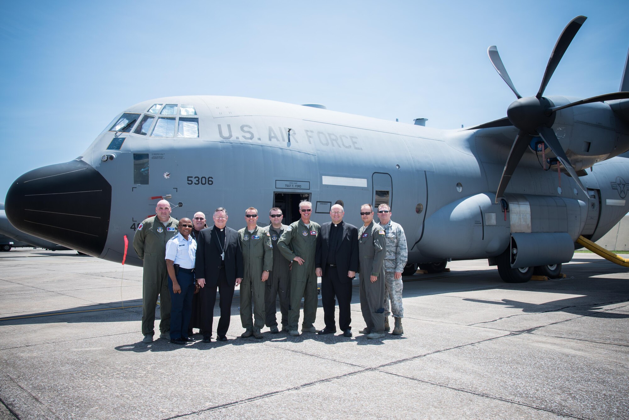 The Bishop of Biloxi, Bishop Louis Kihneman, and members of the 53rd Weather Reconnaissance Squadron, pose for a photo in front of a WC-130J Super Hercules aircraft Aug. 17, 2017 at Keesler Air Force Base, Mississippi. Kihneman visited the 403rd Wing to learn more about its mission and during his visit took a moment to bless the wing's fleet of aircraft.  (U.S. Air Force photo/Staff Sgt. Heather Heiney)