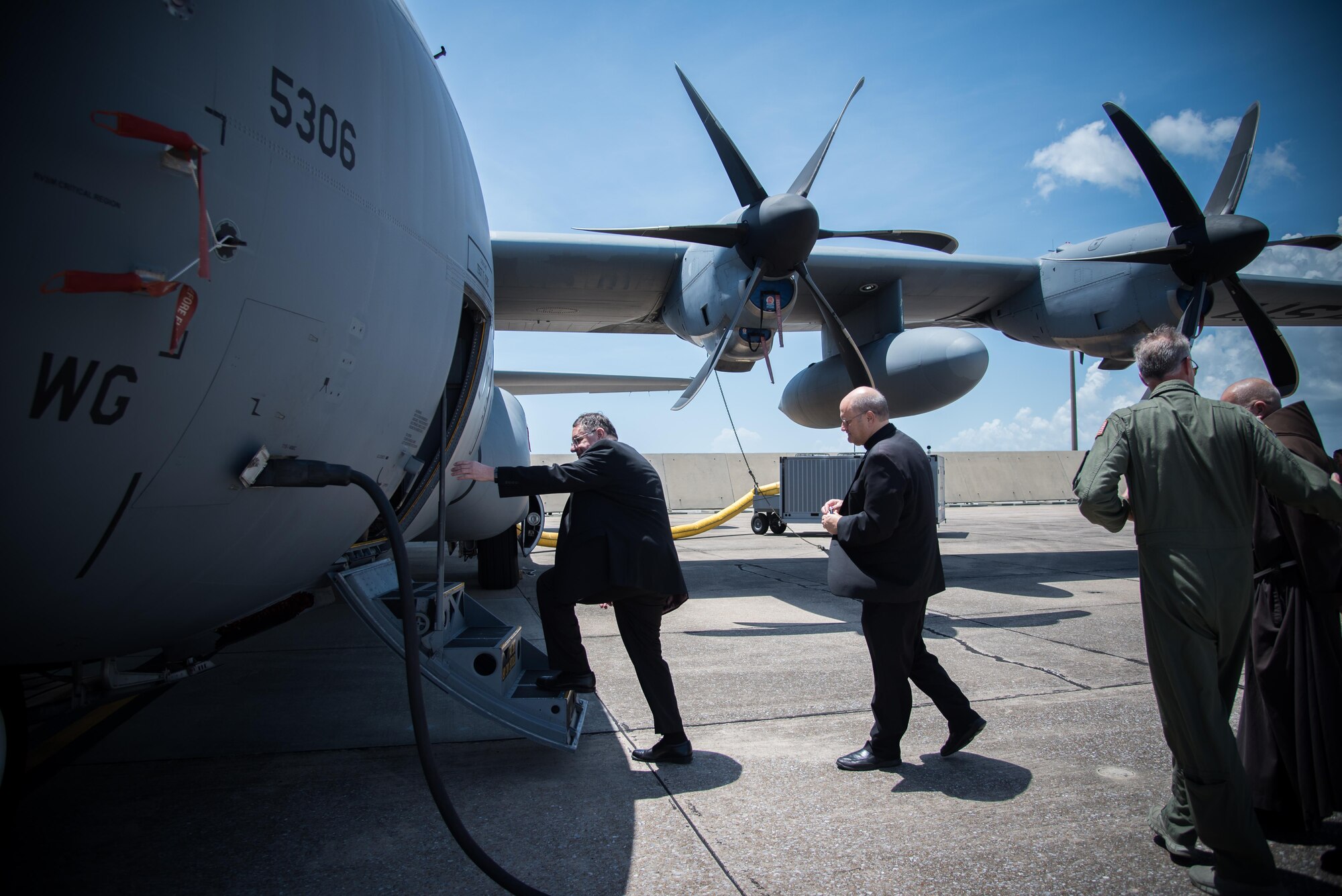 The Bishop of Biloxi, Bishop Louis Kihneman, boards a WC-130J Super Hercules aircraft Aug. 17, 2017 at Keesler Air Force Base Mississippi. Kihneman visited the 403rd Wing to learn more about its mission and during his visit took a moment to bless the wing's fleet of aircraft. (U.S. Air Force photo/Staff Sgt. Heather Heiney)